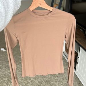 SKIMS beige/ tan long sleeve shirt.